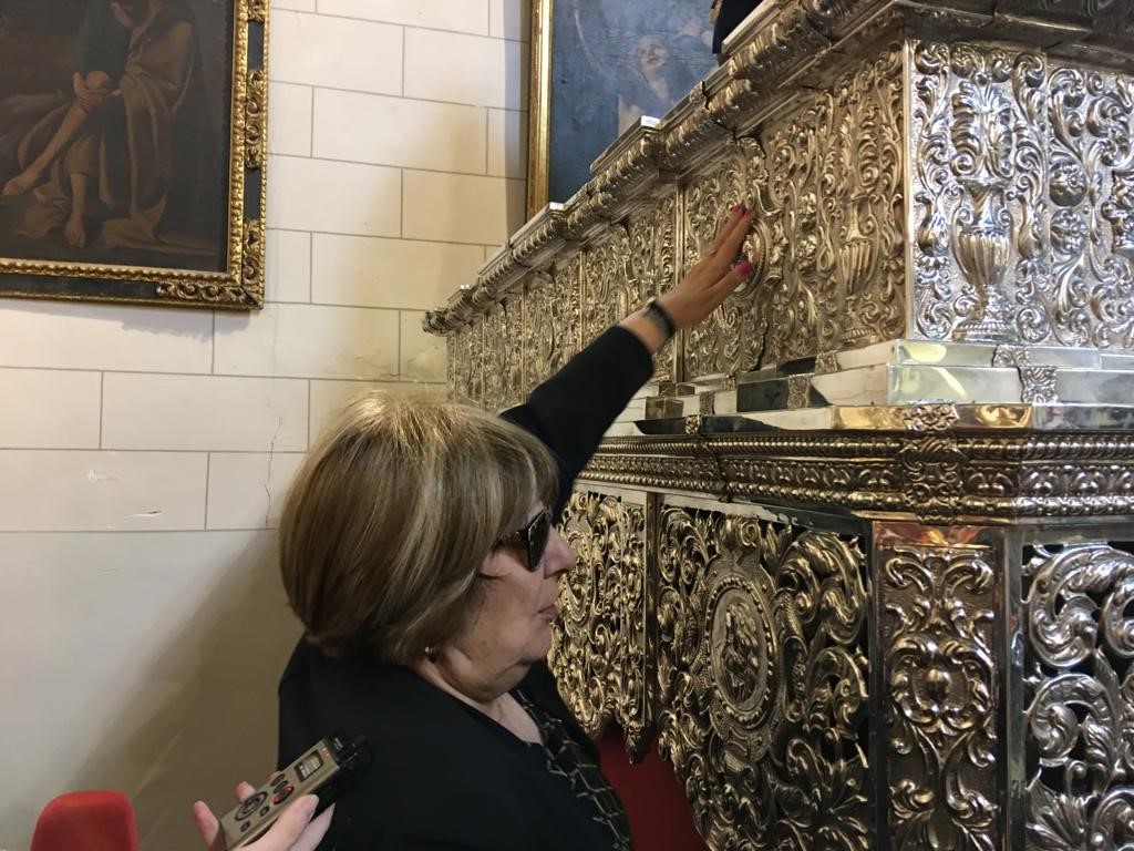 Afiliada de Toledo tocando el relieve de un paso de Semana Santa