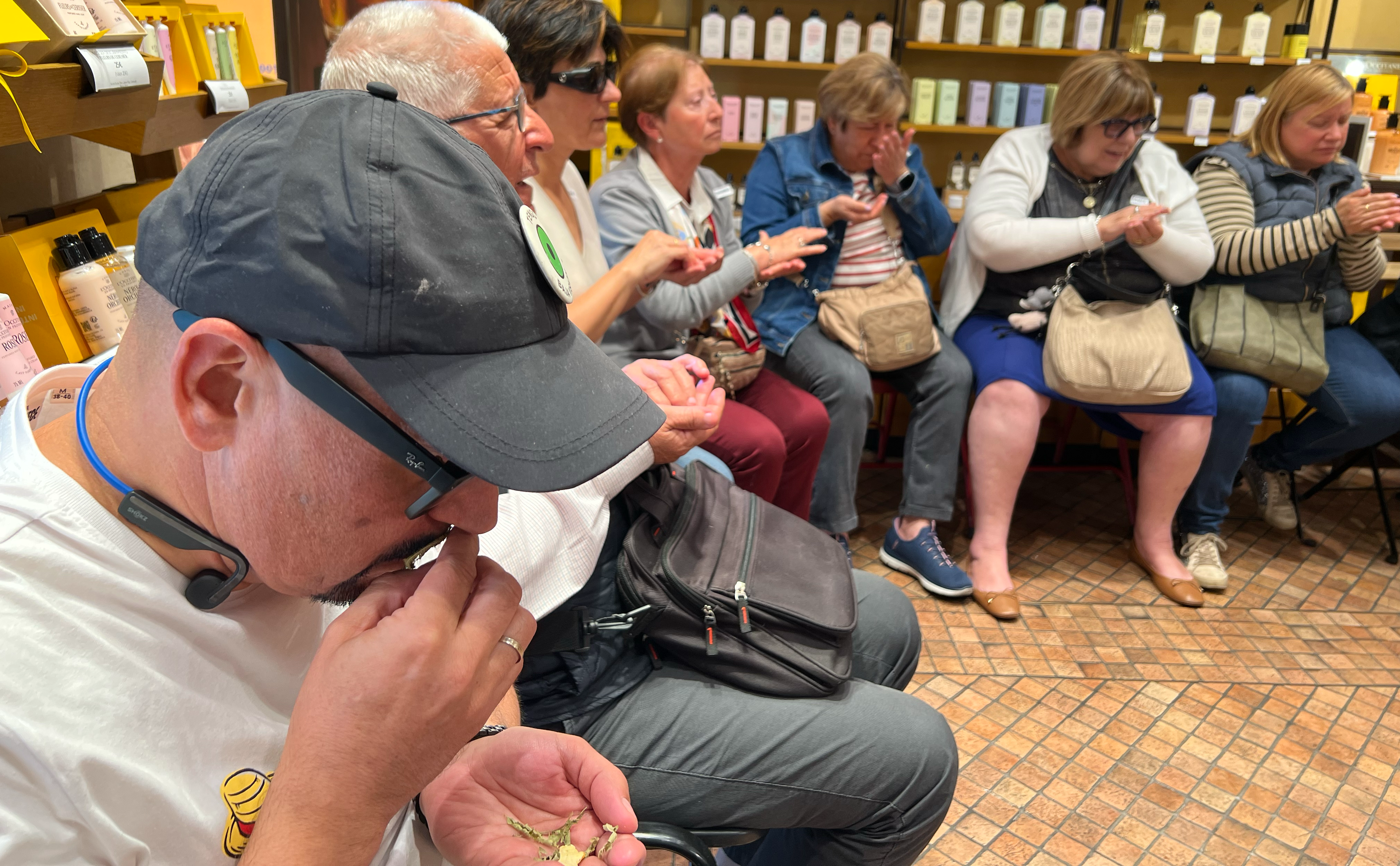 Miembros del club braille de Toledo oliendo diferentes elementos durante el taller sensorial